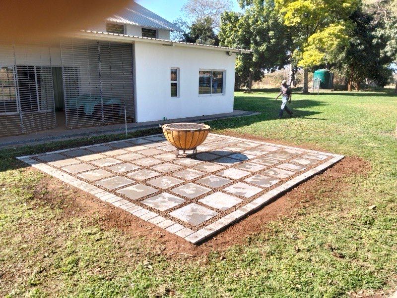 Two-tone paver patio with fire pit bowl for outdoor entertainment
