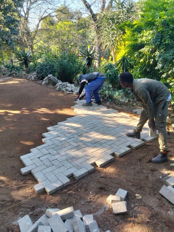 Flagstone slab paving with sand joints on open lawn